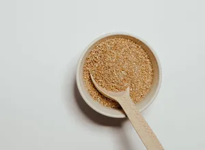 Psyllium husk in a small bowl with a wooden spoon